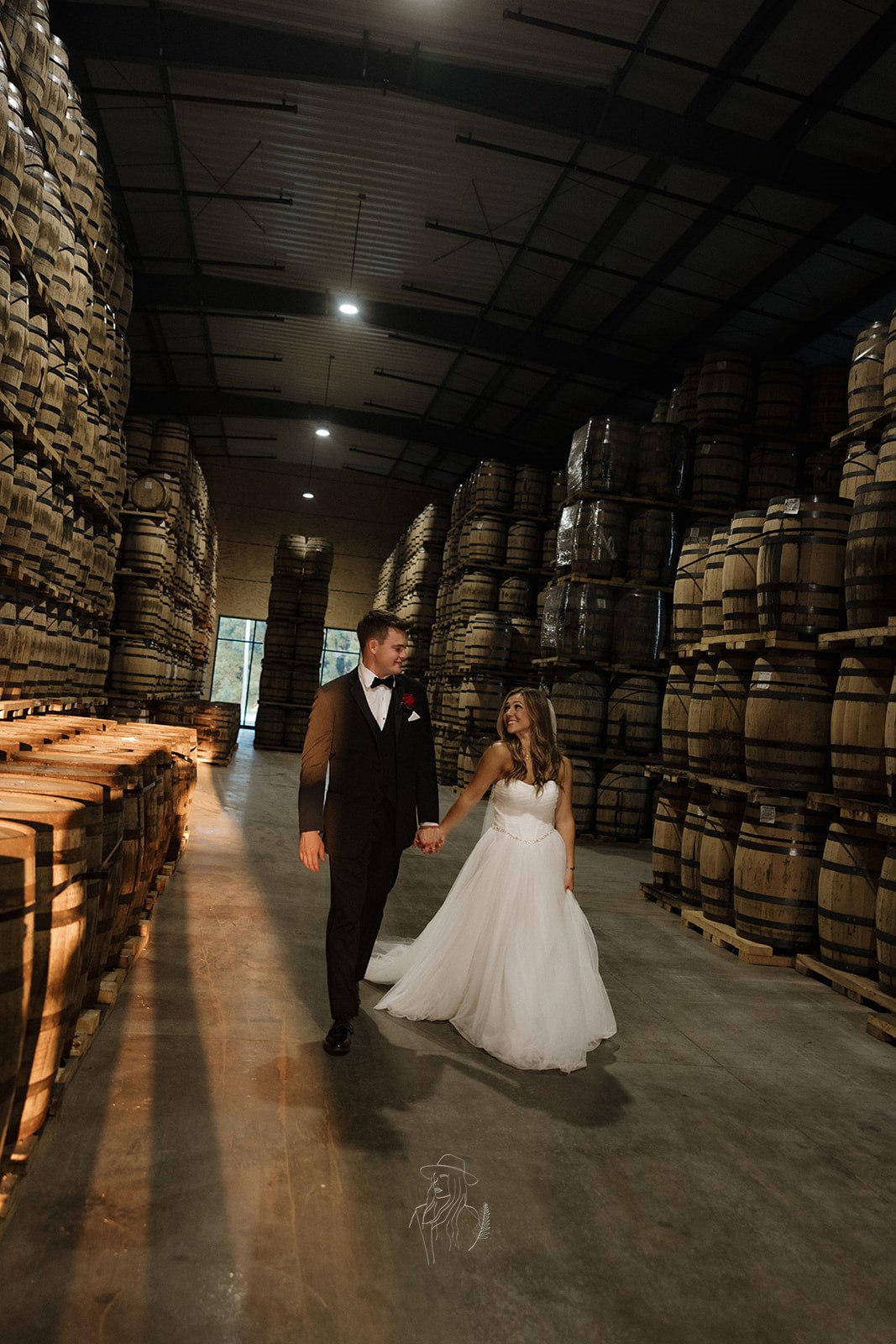 Couple walking hand in hand through the rack house