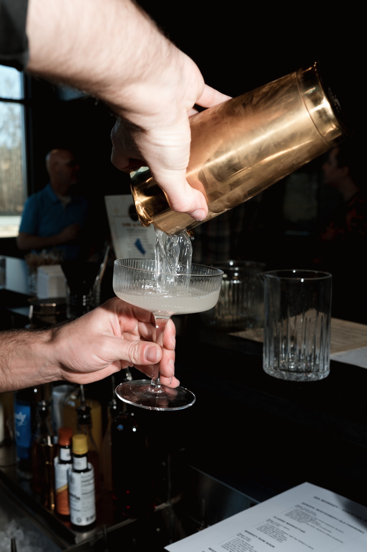 Bartender pouring a craft cocktail