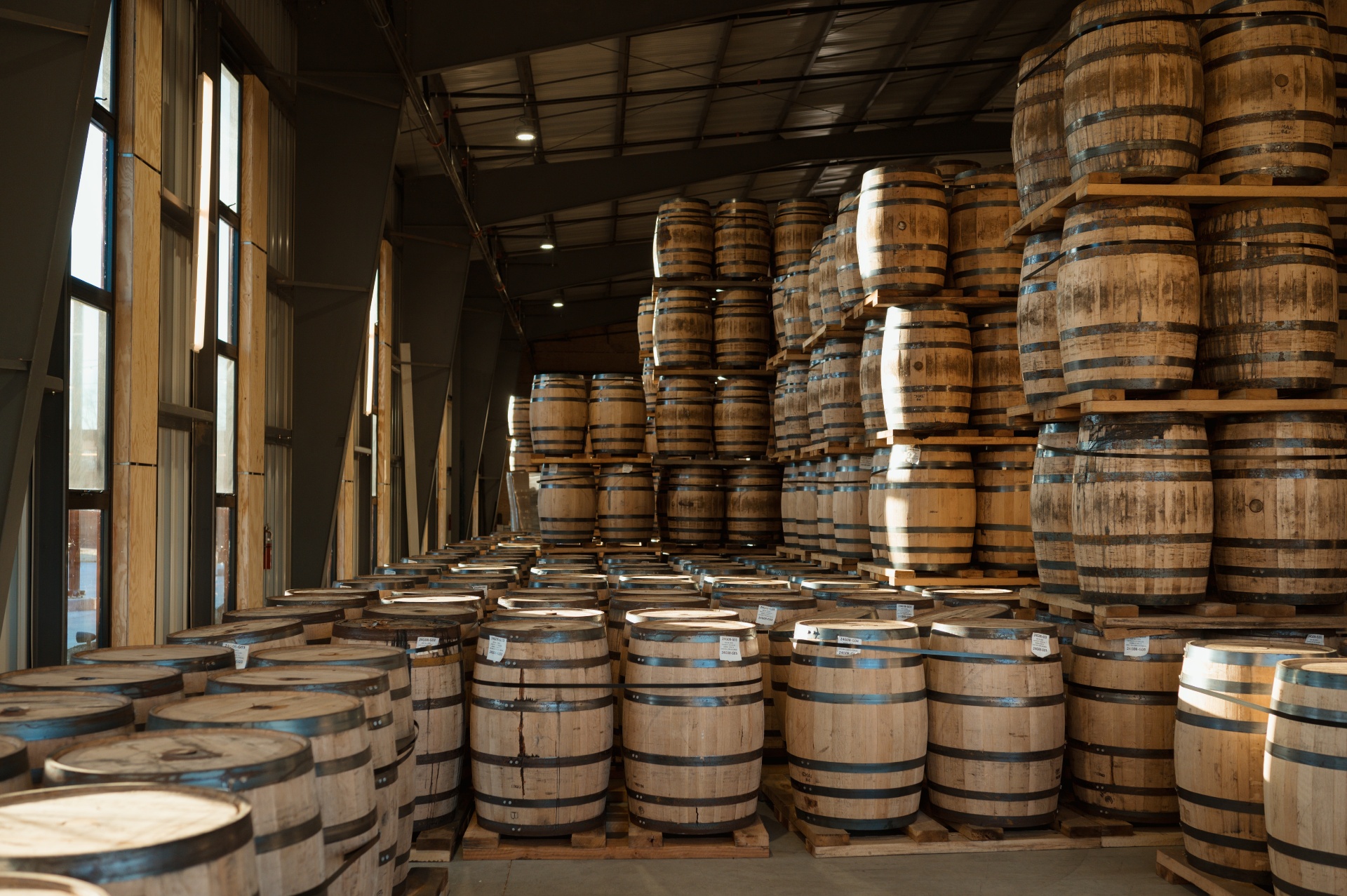 The Barrel Room rack house with stacked bourbon barrels