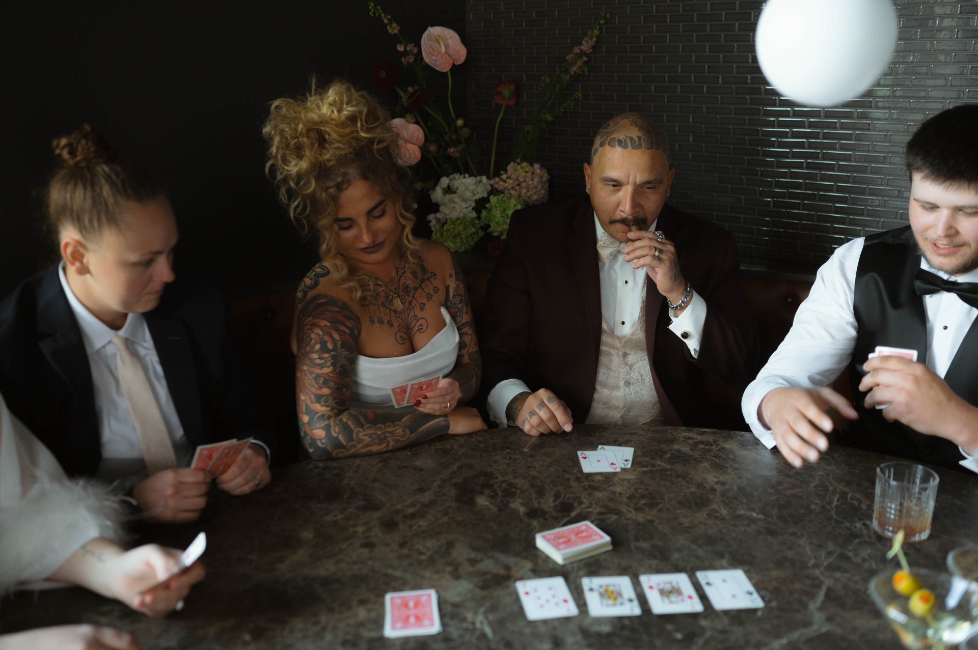 Wedding party playing cards in the Speakeasy lounge