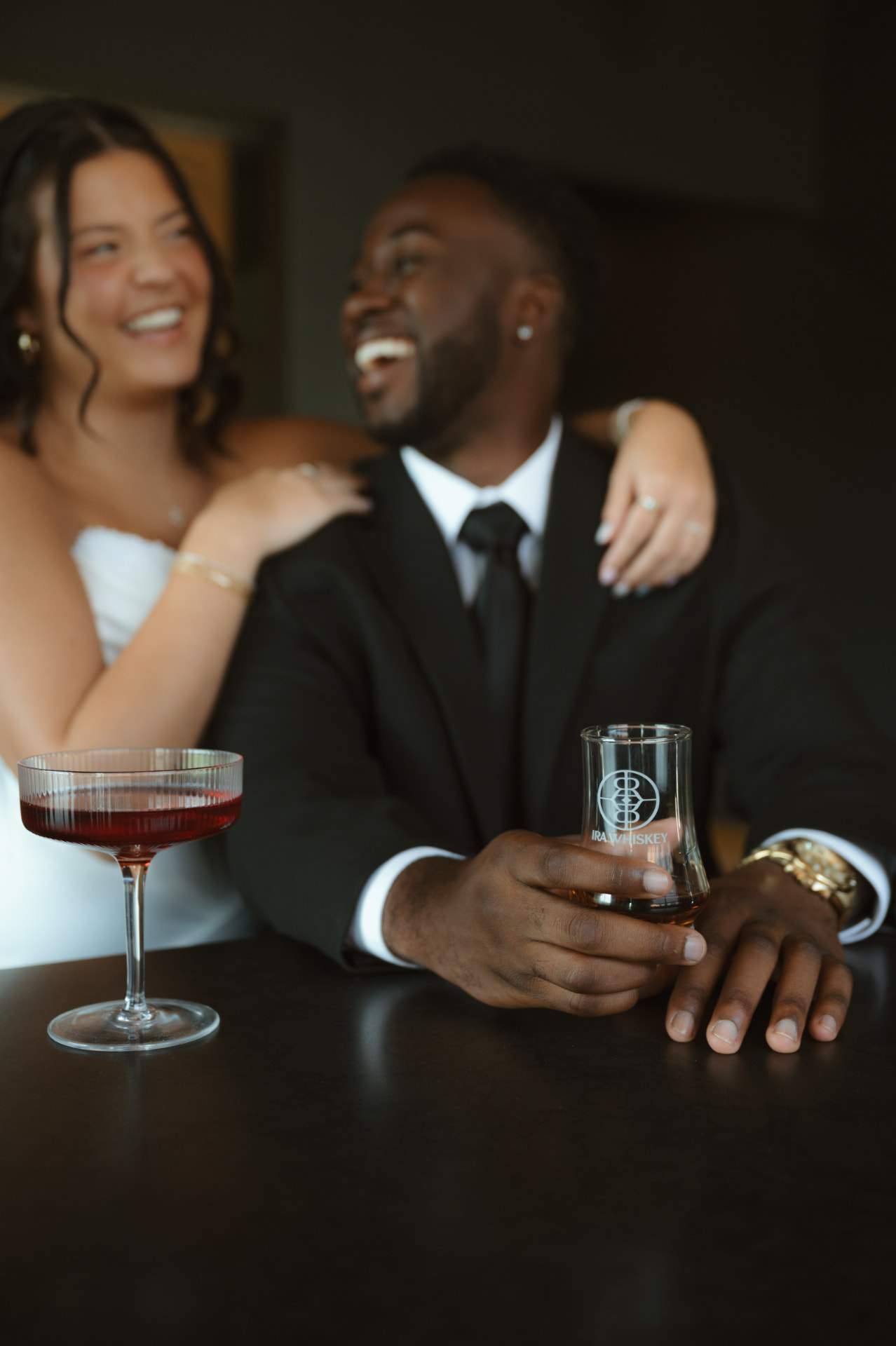 Bride and groom sharing a toast with IRA Whiskey glass