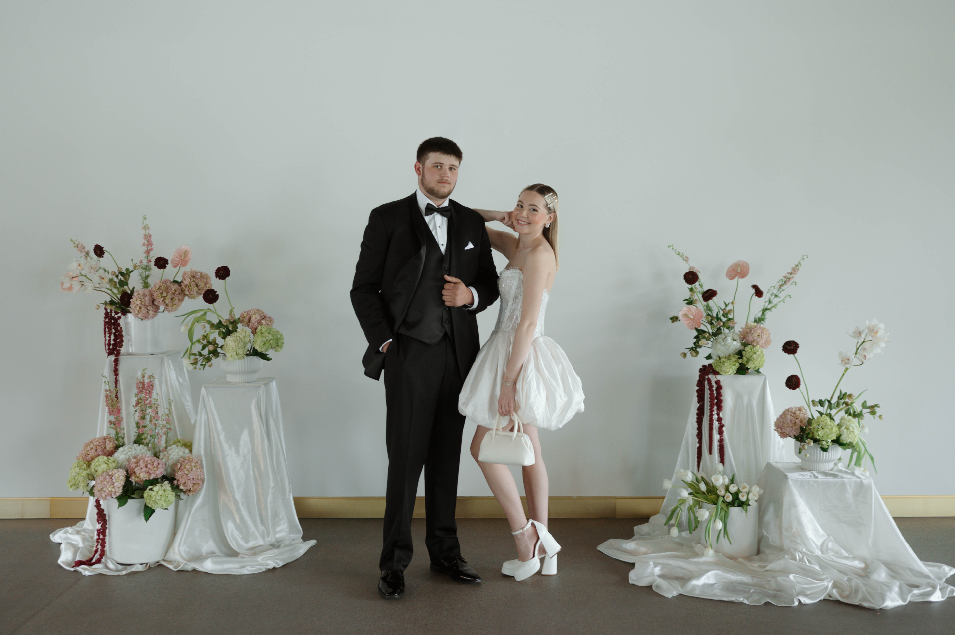 Bride and groom sharing a moment behind a tower of martini glasses at The Barrel Room