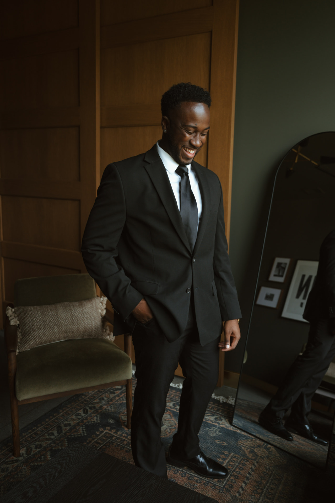 Groom smiling in the groom's suite