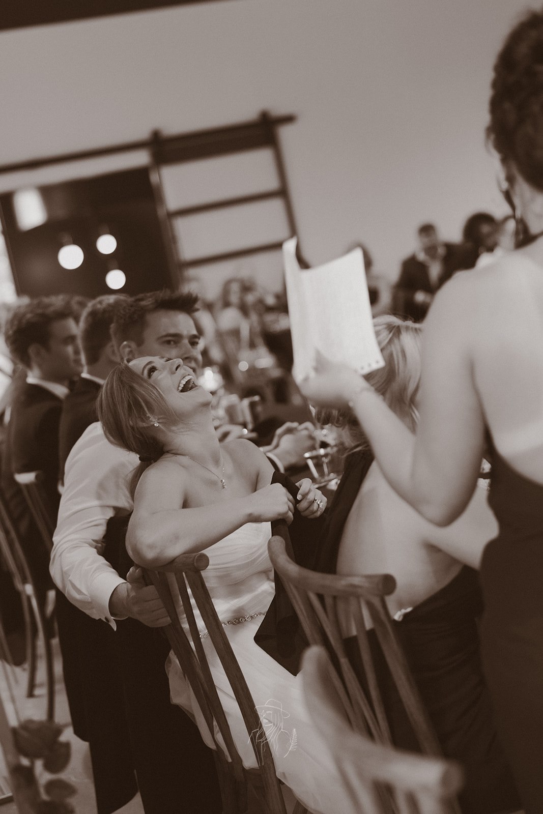 Bride laughing during reception toasts