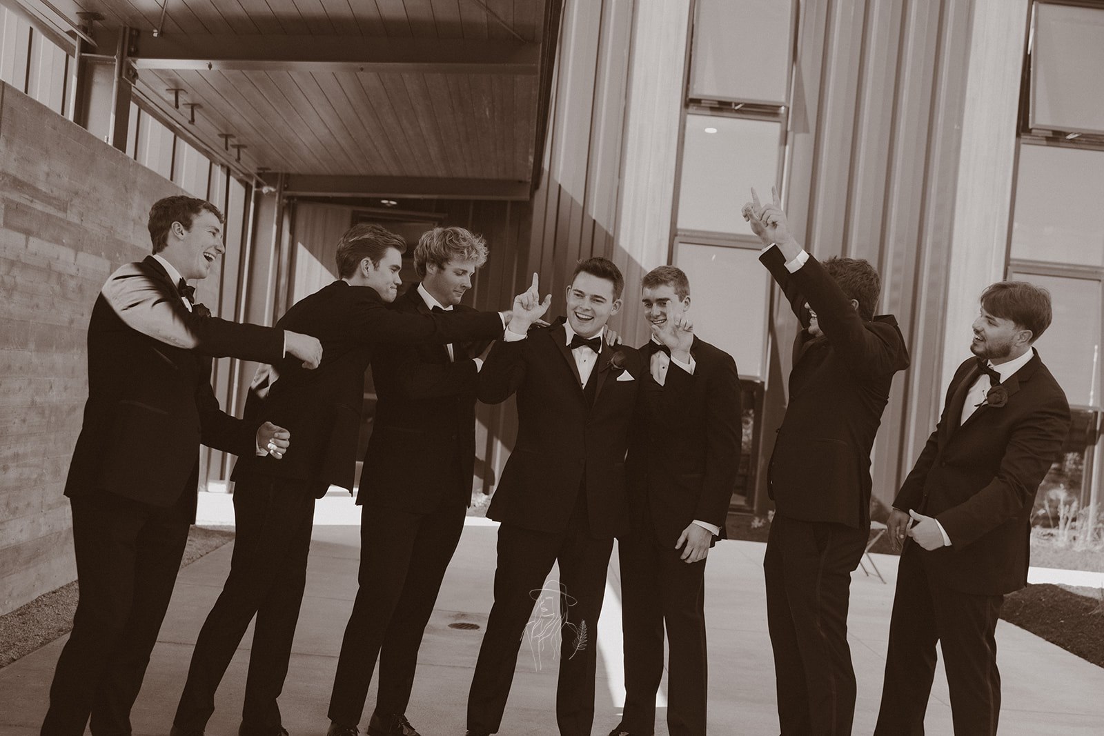 Groom and groomsmen celebrating in the breezeway